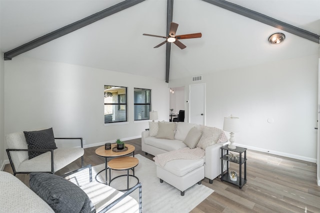 living room featuring lofted ceiling with beams, light hardwood / wood-style floors, and ceiling fan