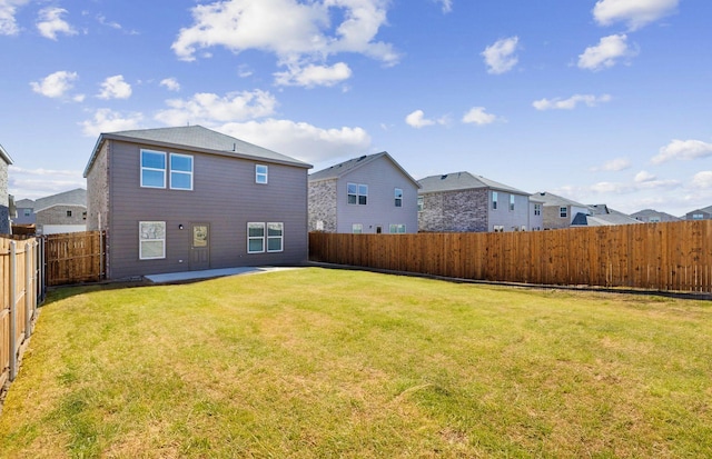 back of property featuring a lawn