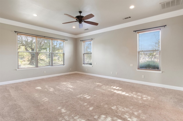 carpeted empty room featuring ceiling fan and crown molding