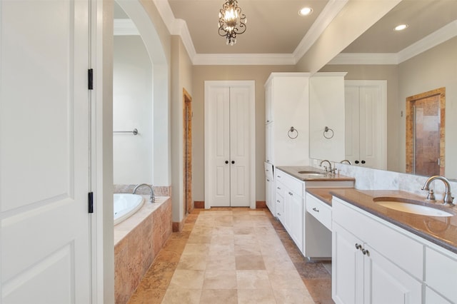 bathroom featuring vanity, tiled tub, crown molding, and a notable chandelier