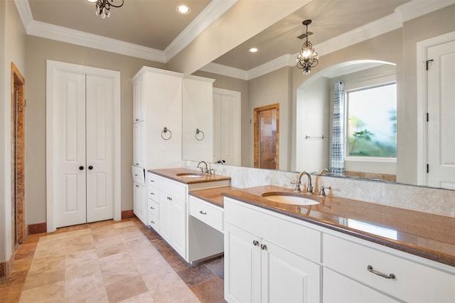 bathroom with ornamental molding and vanity