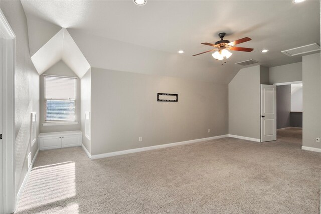 bonus room with lofted ceiling, light colored carpet, and ceiling fan