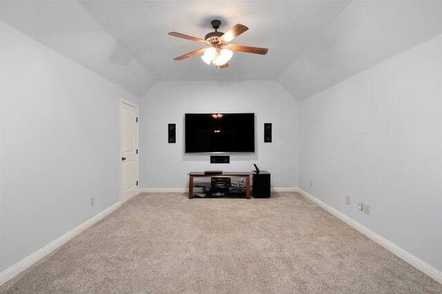 carpeted living room with ceiling fan and lofted ceiling