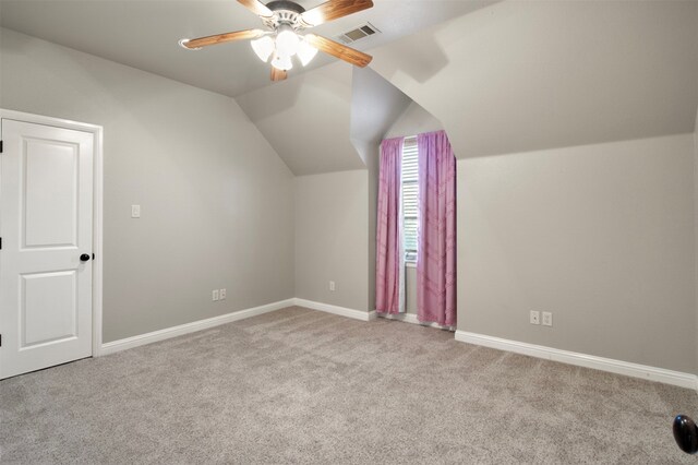 additional living space with light carpet, ceiling fan, and vaulted ceiling