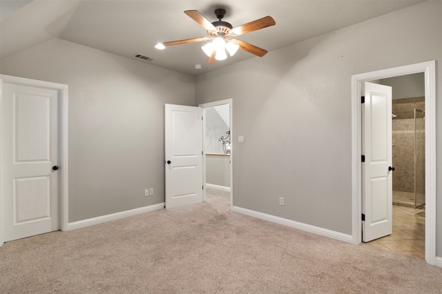 unfurnished bedroom featuring light colored carpet, lofted ceiling, and ceiling fan