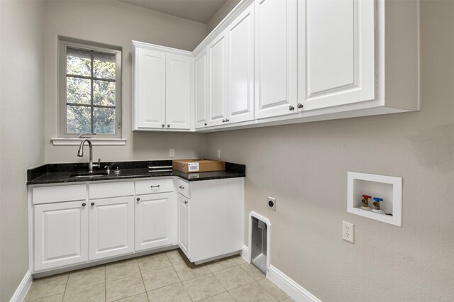 laundry area featuring electric dryer hookup, cabinets, sink, light tile patterned flooring, and hookup for a washing machine