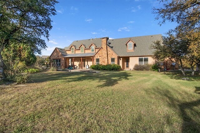 rear view of property with a yard