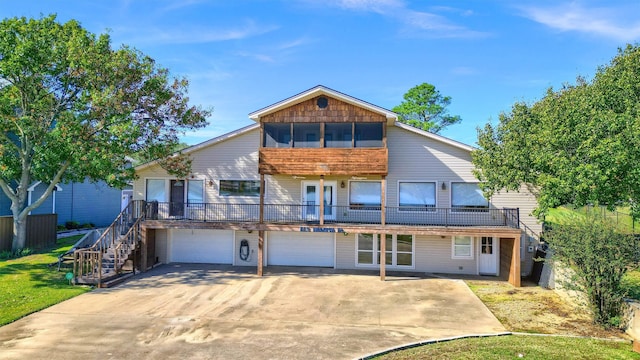 view of front of home featuring a garage and a sunroom