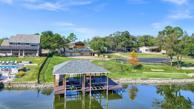 dock area with a water view and a yard