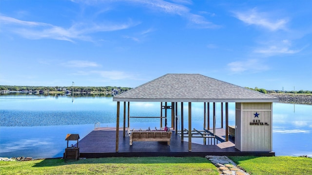 view of dock featuring a water view and a lawn