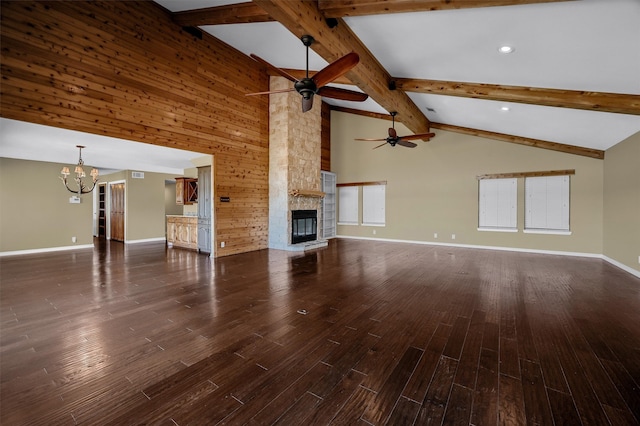 unfurnished living room featuring a stone fireplace, high vaulted ceiling, dark hardwood / wood-style flooring, and beamed ceiling