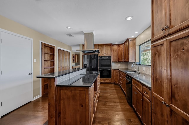 kitchen with sink, black appliances, dark hardwood / wood-style floors, a center island, and island exhaust hood