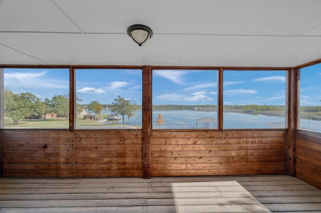 unfurnished sunroom with a water view