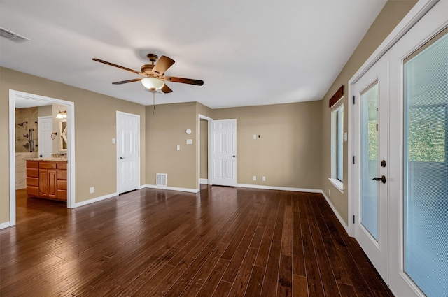 interior space with dark wood-type flooring and ceiling fan