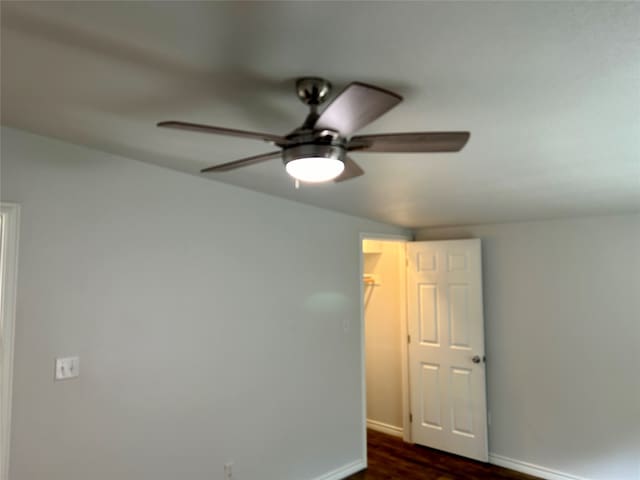 unfurnished room featuring ceiling fan and dark hardwood / wood-style flooring