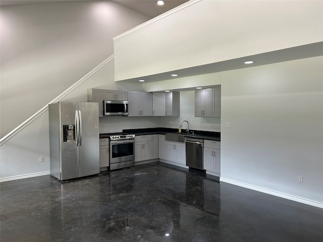 kitchen with gray cabinets, appliances with stainless steel finishes, sink, and ornamental molding