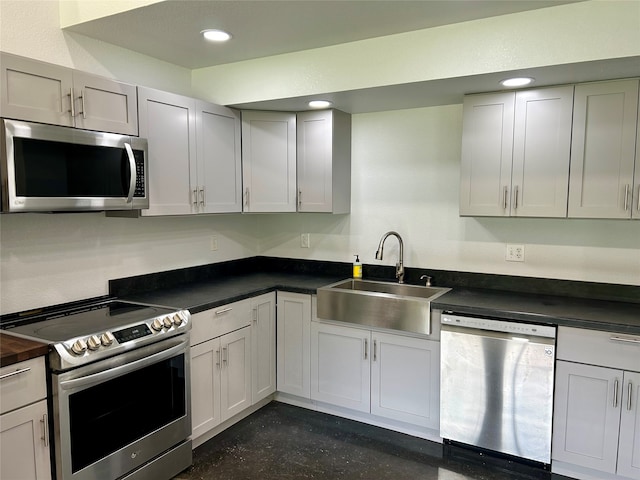 kitchen featuring stainless steel appliances, white cabinets, and sink