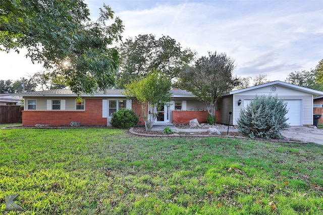 ranch-style home with a garage and a front yard