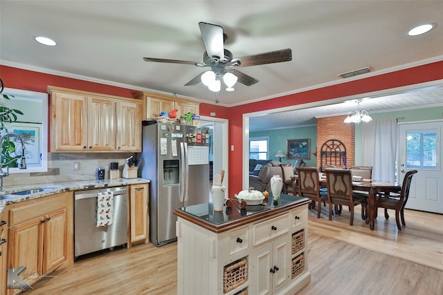 kitchen featuring ceiling fan with notable chandelier, appliances with stainless steel finishes, sink, and light hardwood / wood-style flooring