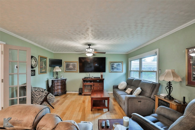 living room featuring a textured ceiling, wood-type flooring, ceiling fan, and crown molding