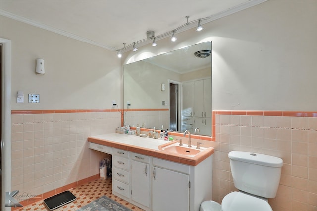 bathroom with vanity, crown molding, and tile walls