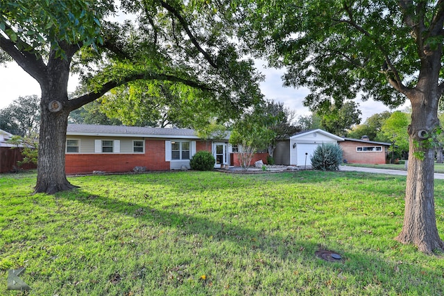 ranch-style home with a garage and a front lawn