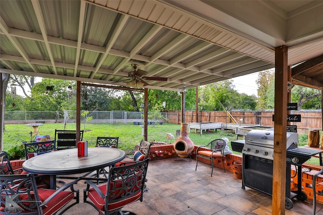 view of patio with a grill, a trampoline, and ceiling fan