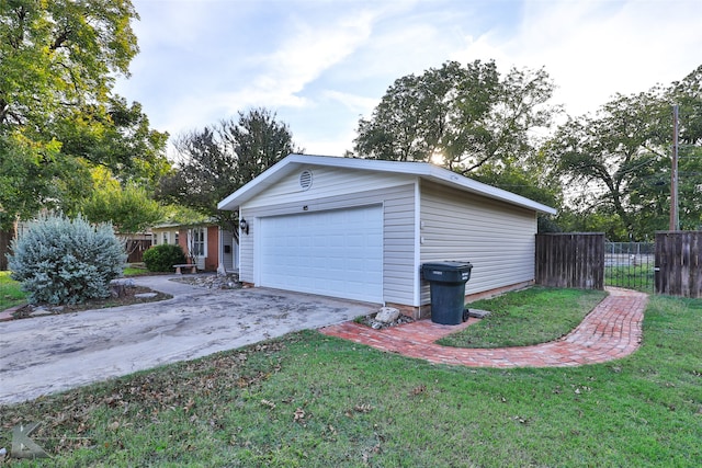 exterior space featuring a garage and a lawn