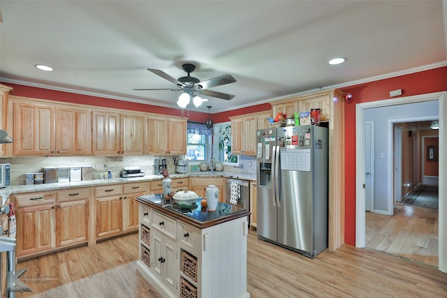 kitchen with crown molding, light hardwood / wood-style flooring, appliances with stainless steel finishes, and a center island