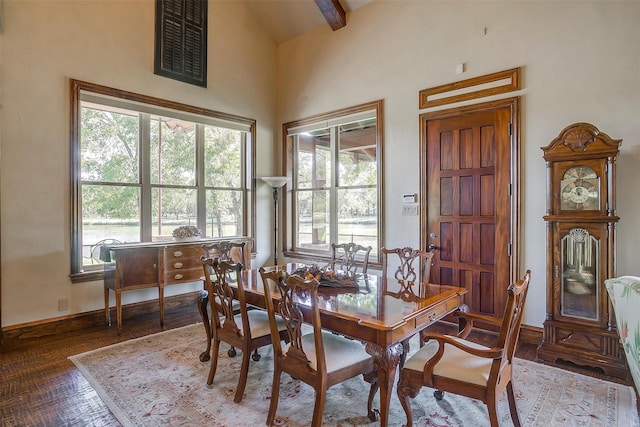 dining space featuring a wealth of natural light, beam ceiling, and high vaulted ceiling