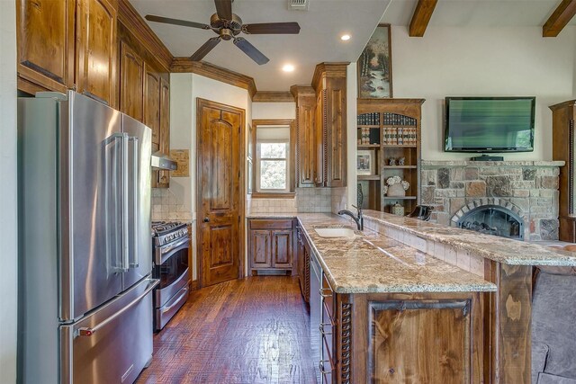 kitchen featuring kitchen peninsula, appliances with stainless steel finishes, dark hardwood / wood-style floors, and beam ceiling