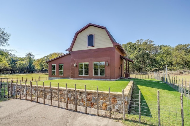 view of home's exterior with a yard and a rural view