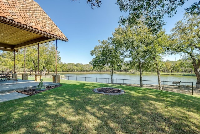 view of yard with a water view and a patio