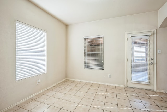 unfurnished room featuring light tile patterned flooring