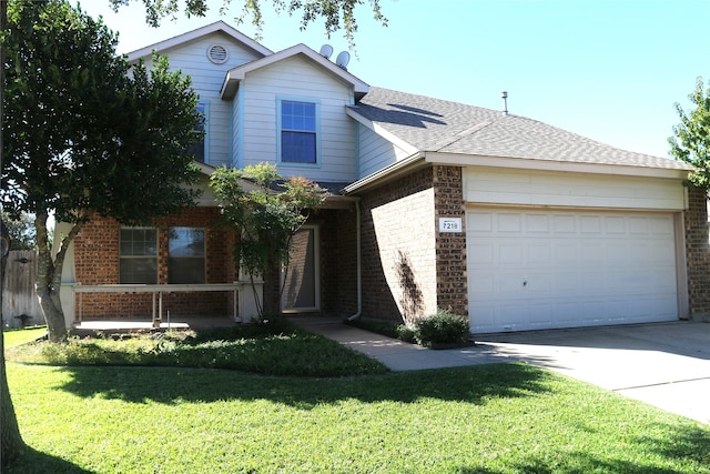 view of front of house featuring a front lawn and a garage