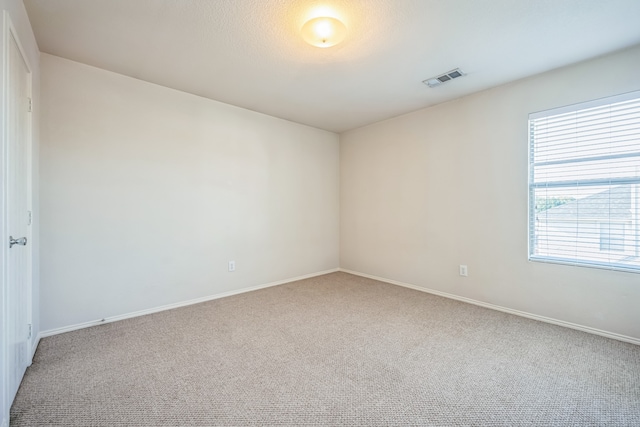 carpeted empty room featuring plenty of natural light