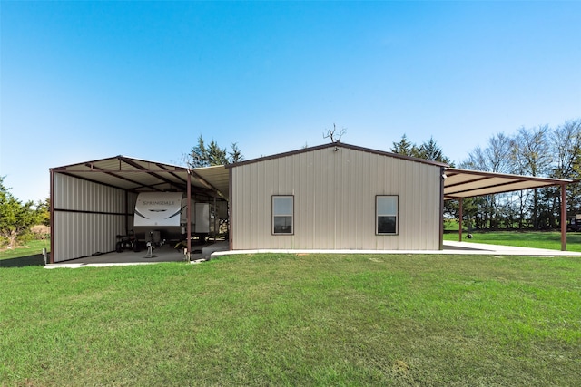 view of outdoor structure featuring a yard and a carport