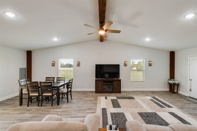 living room featuring vaulted ceiling with beams, plenty of natural light, ceiling fan, and light wood-type flooring