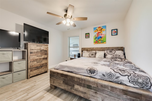 bedroom with ceiling fan and light hardwood / wood-style floors