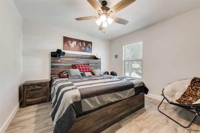 bedroom with light hardwood / wood-style floors and ceiling fan