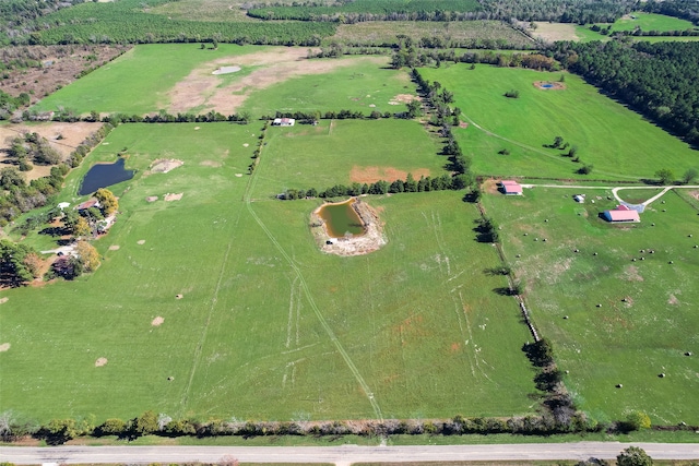 birds eye view of property featuring a rural view and a water view