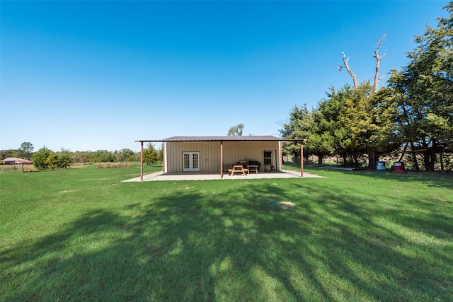 rear view of house featuring a patio area and a yard