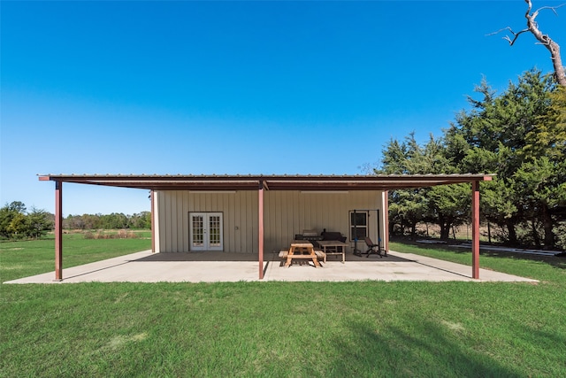 back of house with a yard, a patio, and french doors