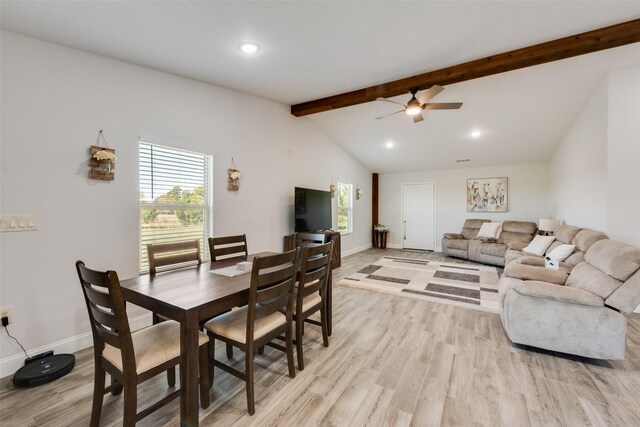 dining room featuring ceiling fan, lofted ceiling with beams, and light hardwood / wood-style floors