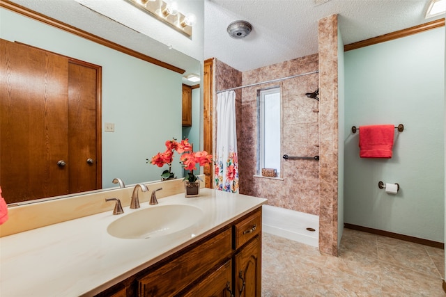 bathroom with tile patterned floors, crown molding, walk in shower, vanity, and a textured ceiling