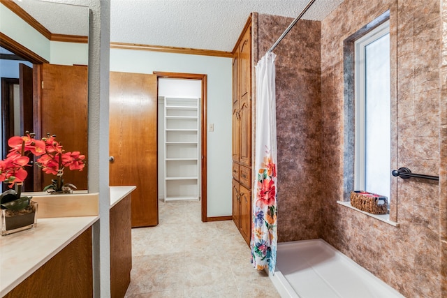 bathroom with crown molding, a textured ceiling, and a shower with curtain