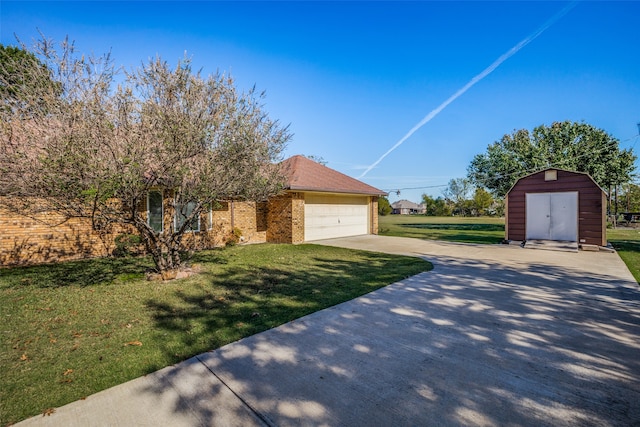 view of front of home with a garage, a shed, and a front lawn