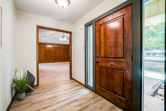 interior space with a textured ceiling and light wood-type flooring