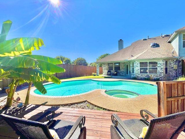 view of swimming pool featuring an in ground hot tub