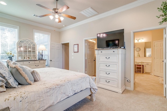 bedroom with ensuite bath, ceiling fan, crown molding, and light colored carpet